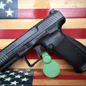 Black handgun on wooden American flag background