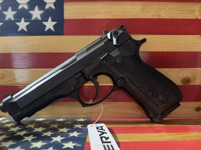 Black handgun on American flag background