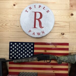 Shotgun displayed over American flag wall decor