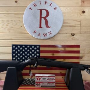 Shotgun on display with American flag backdrop