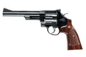 Polished revolver with wooden grip on white background