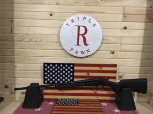 Rifle displayed in front of American flag