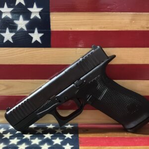 Black semi-automatic pistol on American flag painted wood